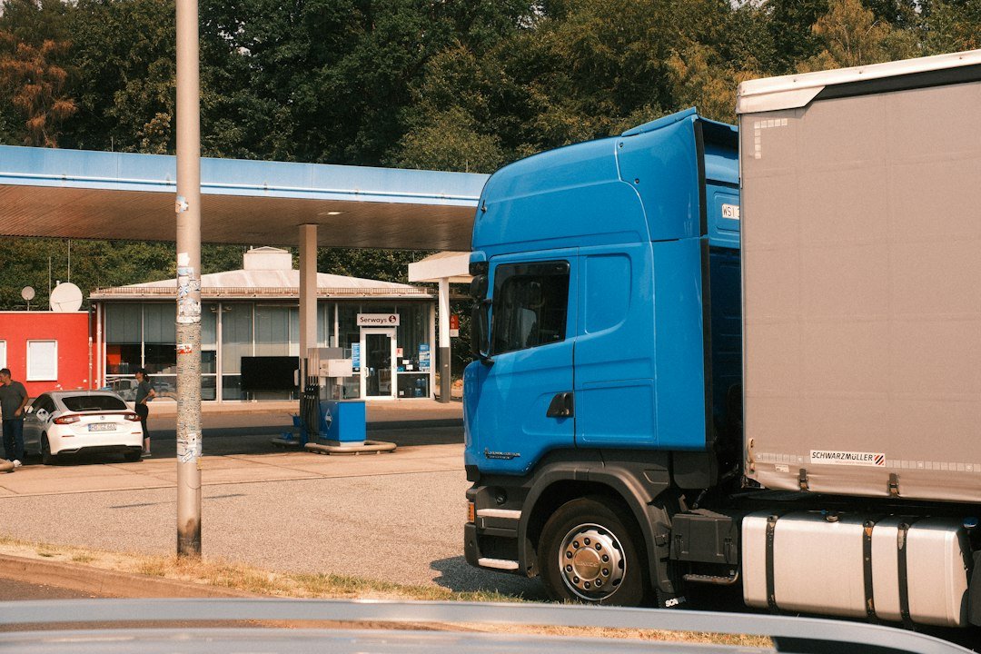 Semi truck at a diesel fuel station, representing fuel cost per mile
